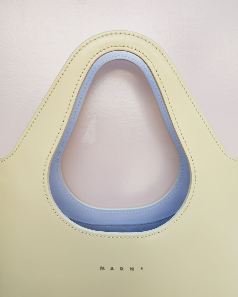 Close-up of a butter yellow Marni bag handle