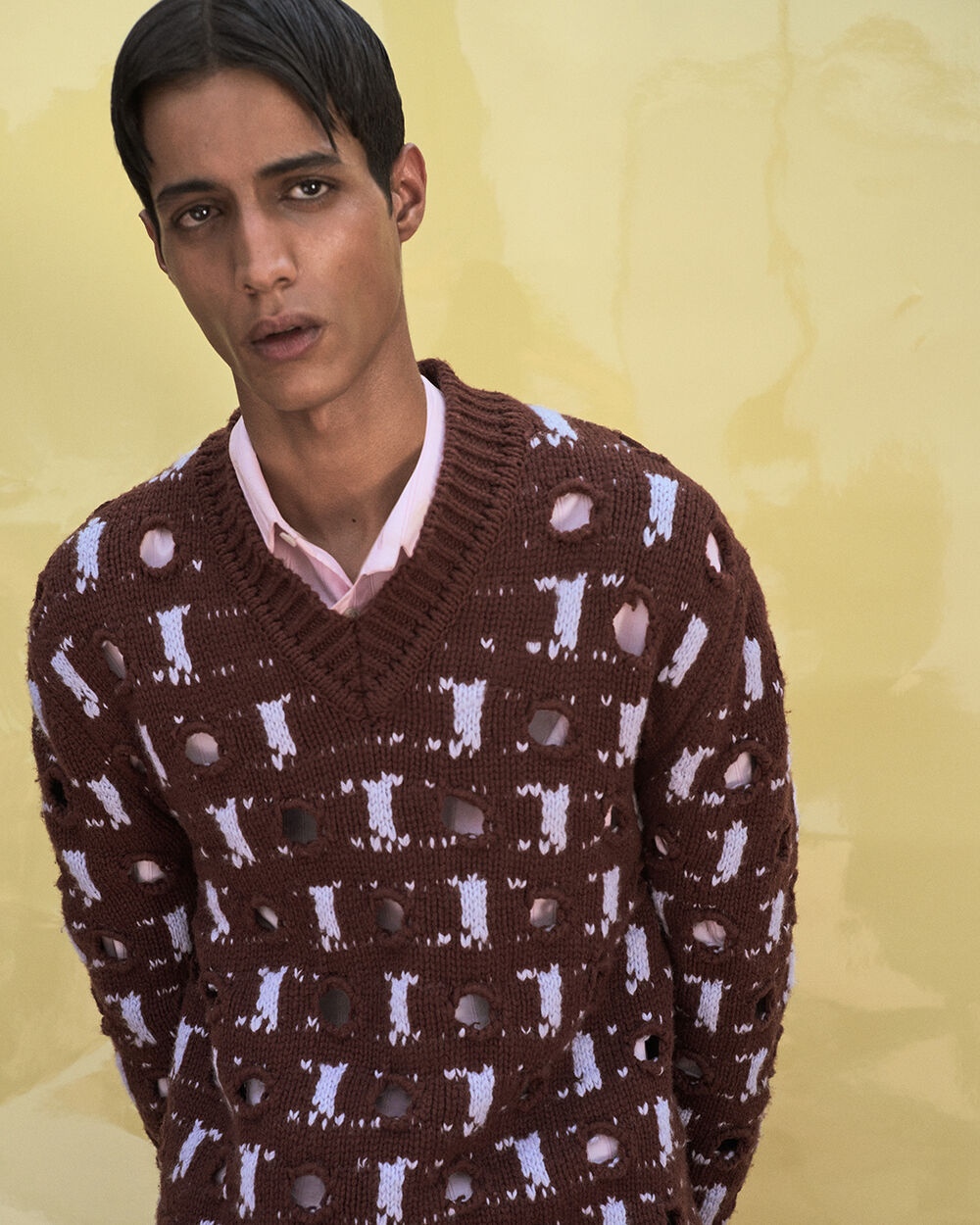 Model wearing a brown Marni V-neck sweater with contrasting abstract knit pattern