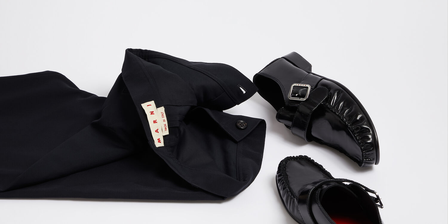 Men&rsquo;s Marni black trousers paired with black leather loafers, styled for a refined back-to-work look