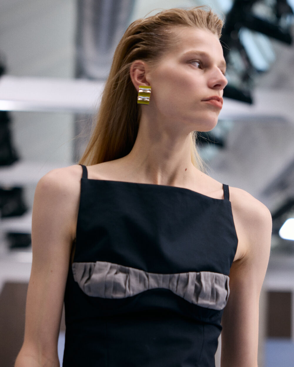Model wearing a black Marni dress with grey gathered detail
