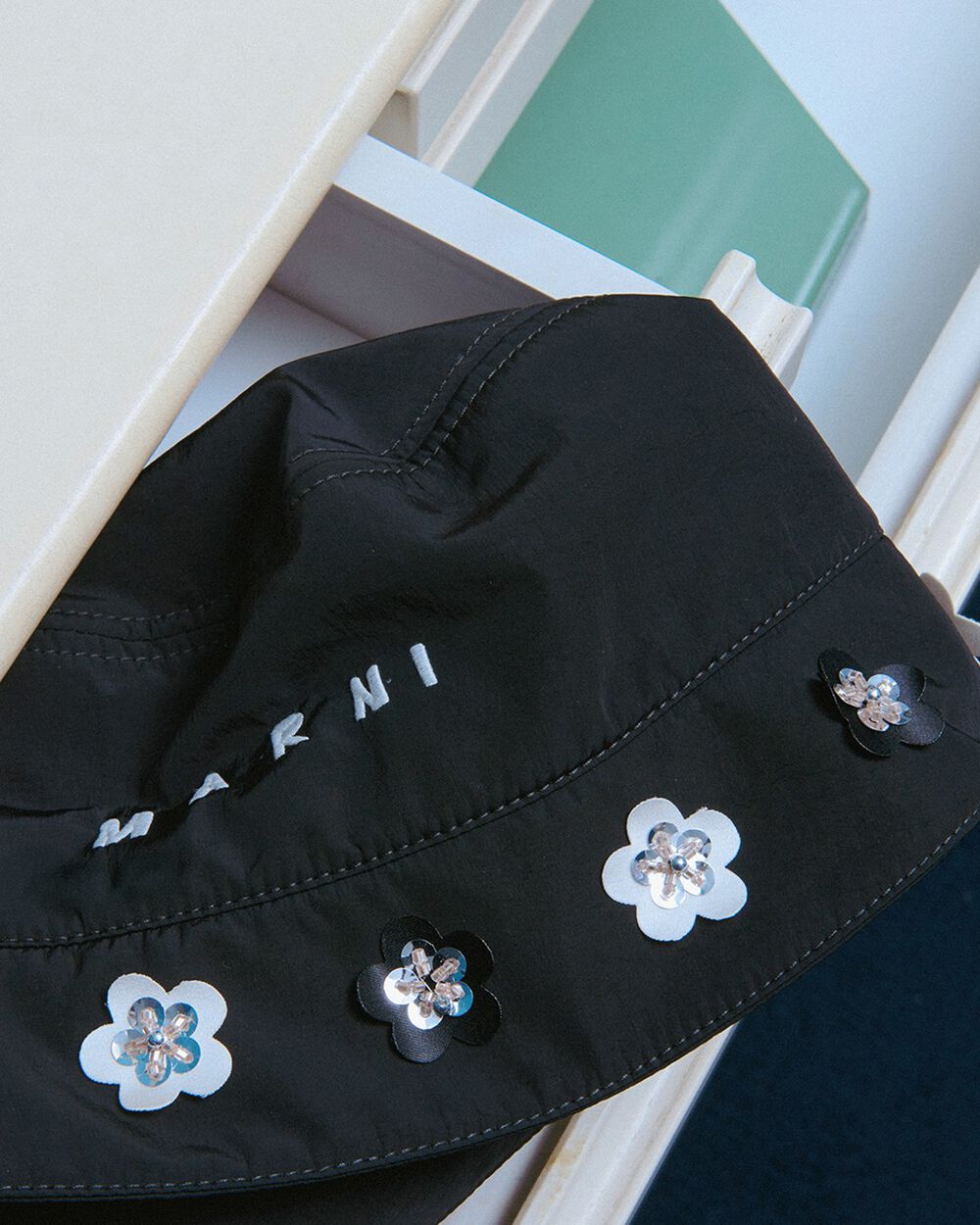 Black taffeta bucket hat with daisy appliqués