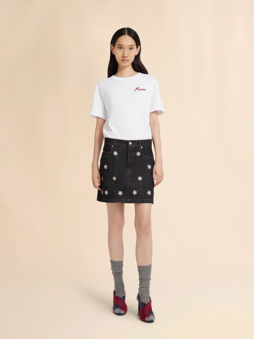 Black denim skirt with daisy appliqués, Image 2