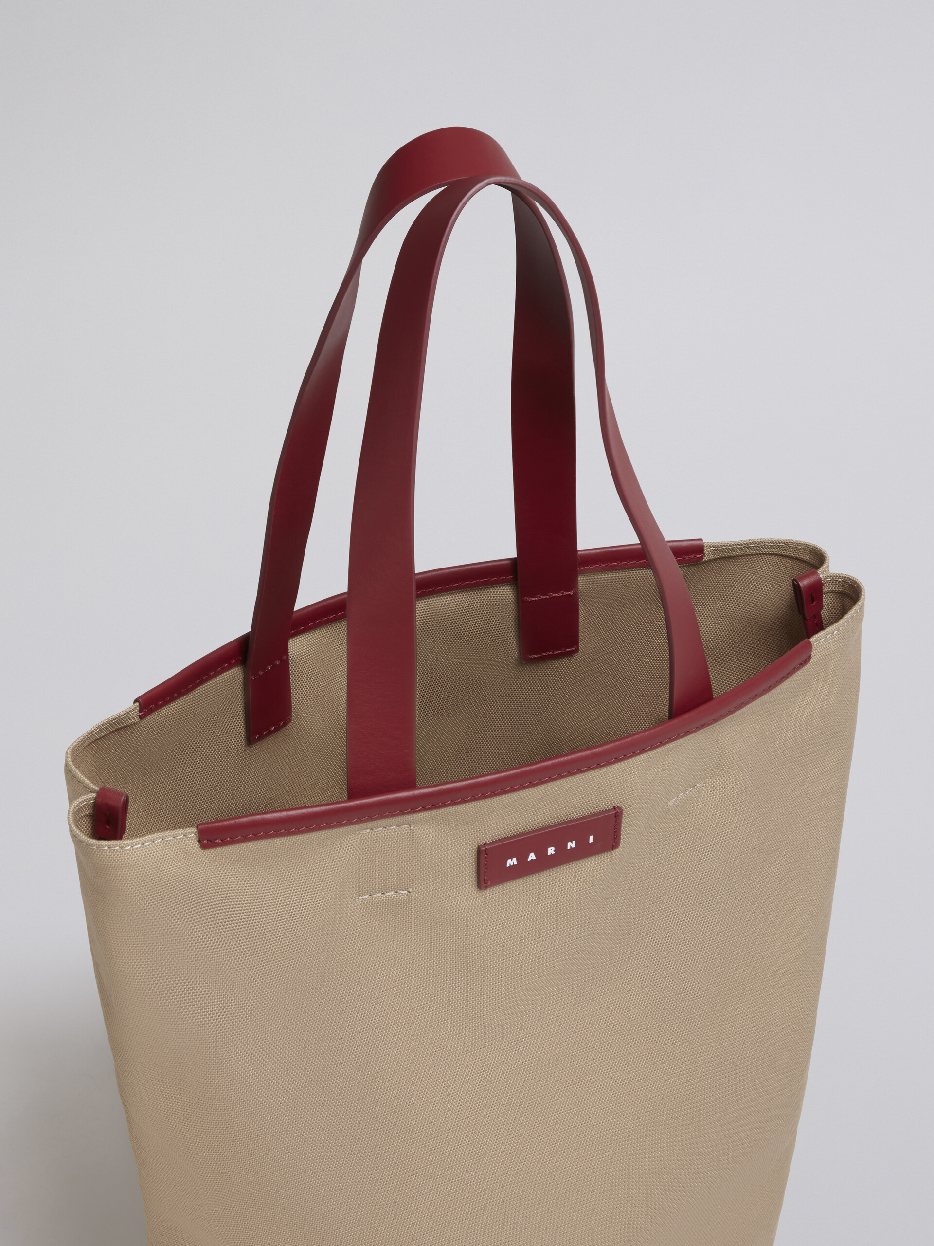 North-South cotton canvas shopping bag with outline bordeaux sprayed motif - Shopping Bags - Image 4
