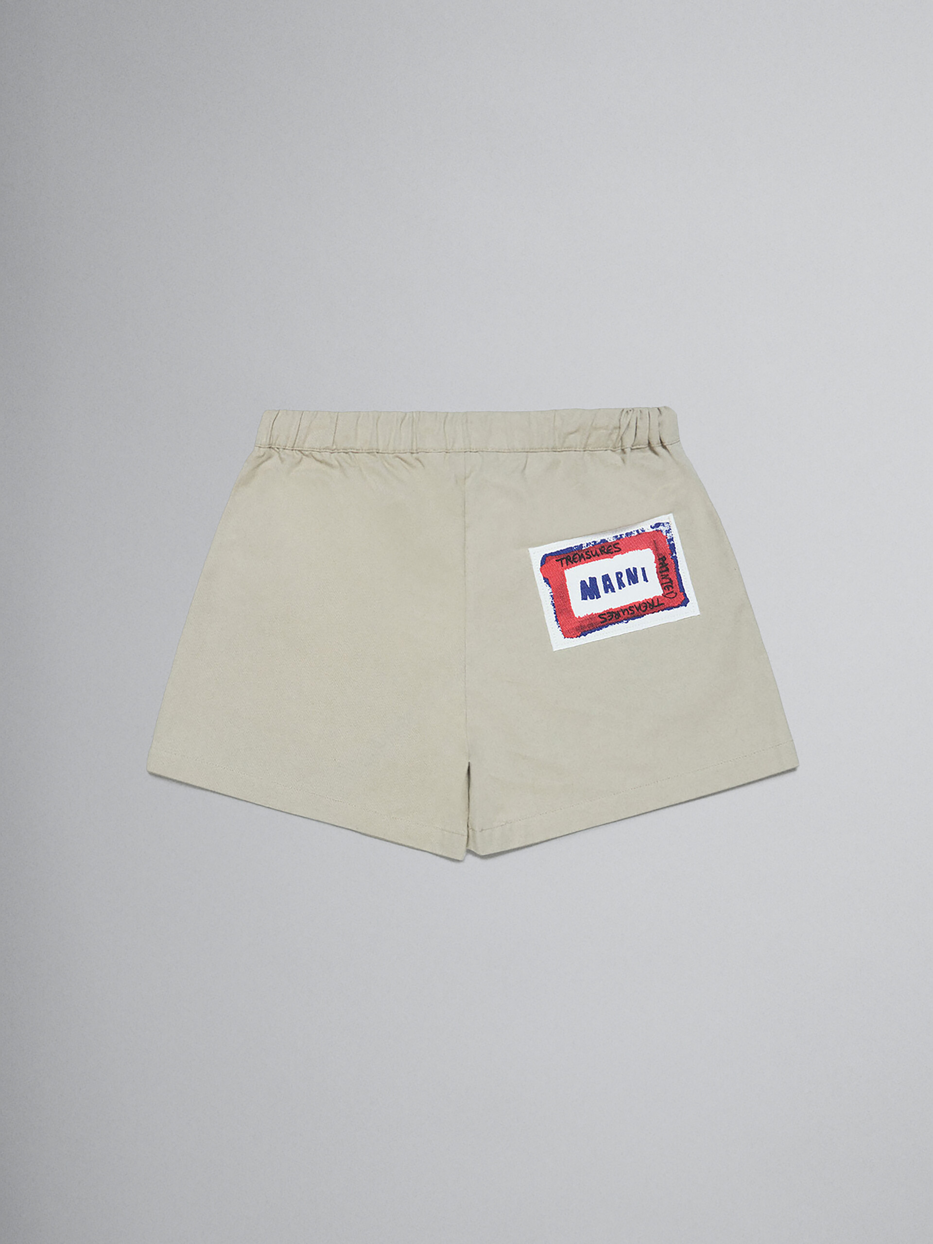 Beige gabardine shorts with printed face - Pants - Image 2