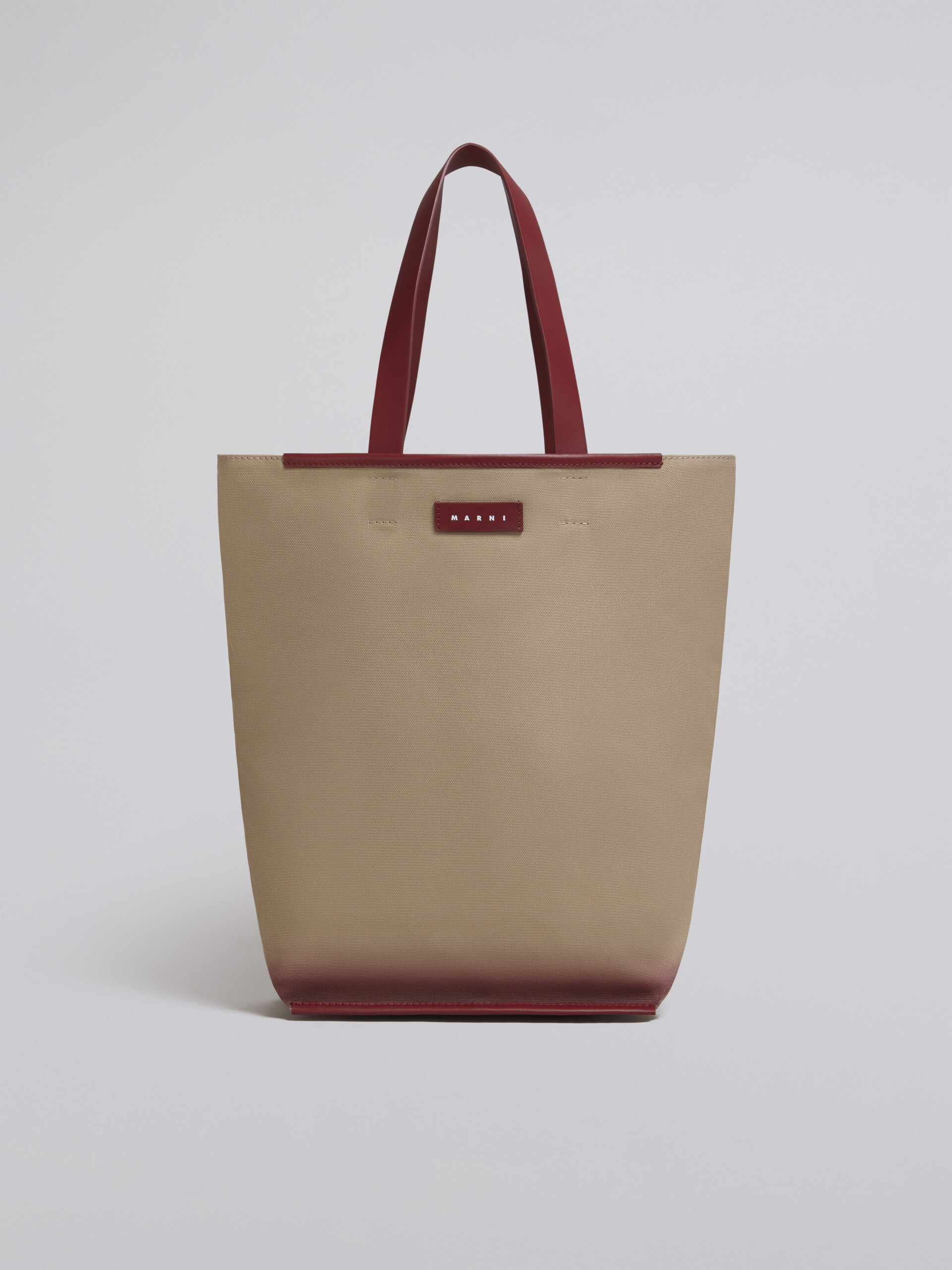 North-South cotton canvas shopping bag with outline bordeaux sprayed motif - Shopping Bags - Image 1