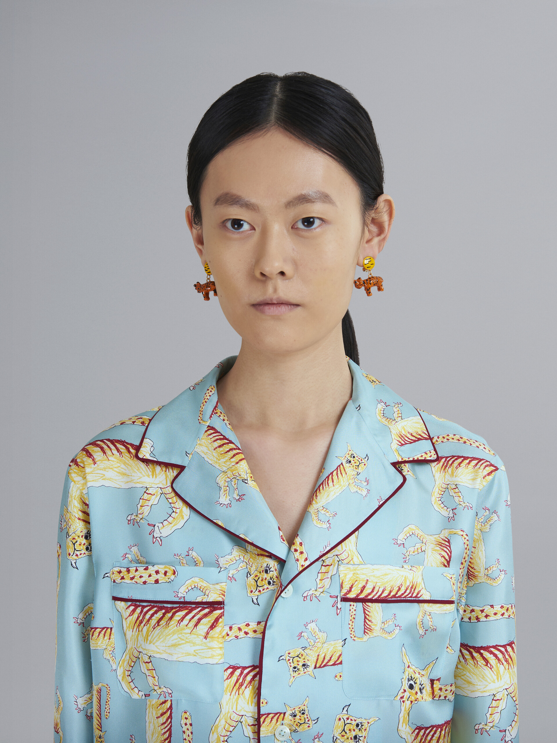 NAIF TIGER clip-on earrings in metal and resin