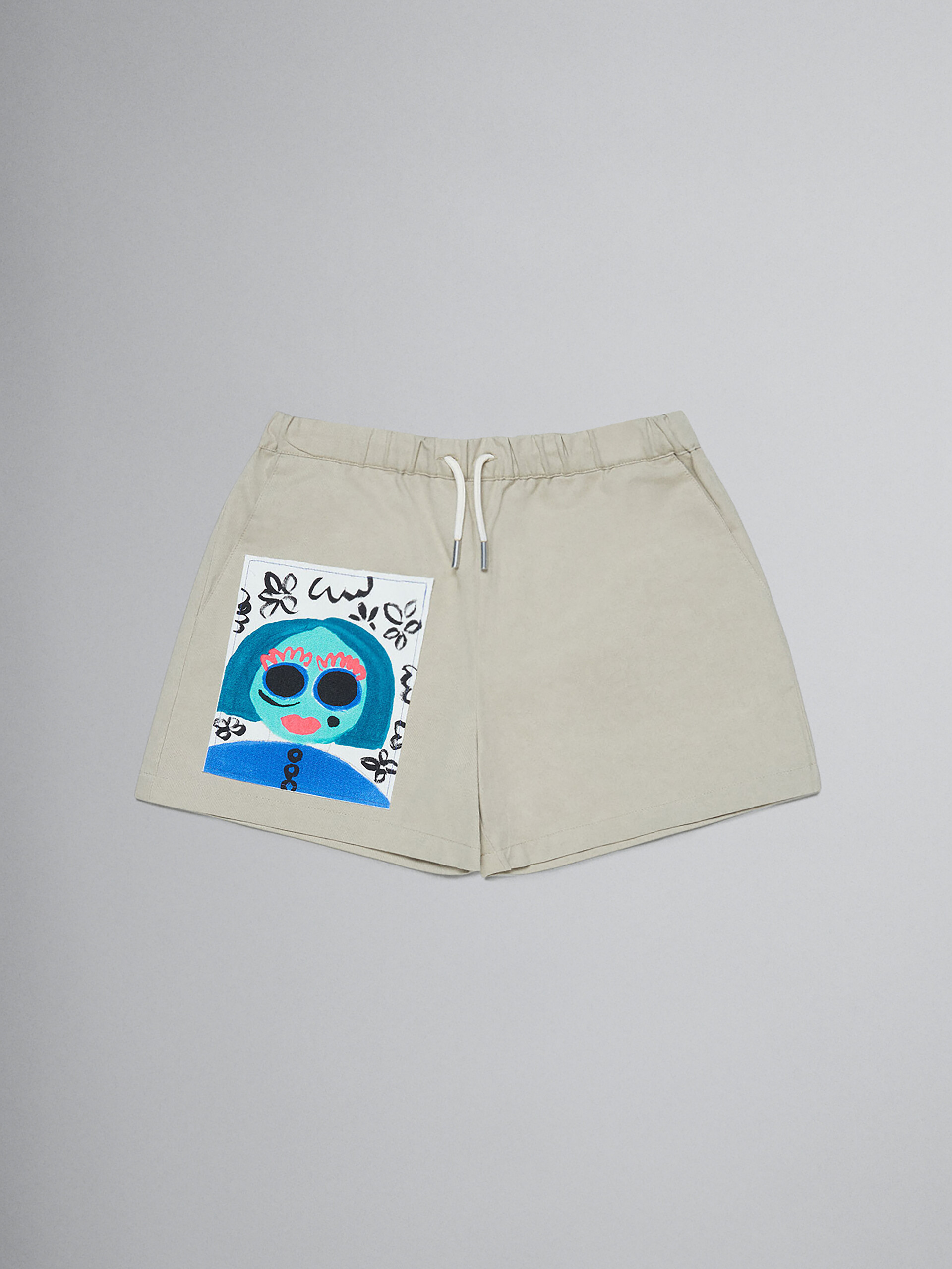 Beige gabardine shorts with printed face - Pants - Image 1