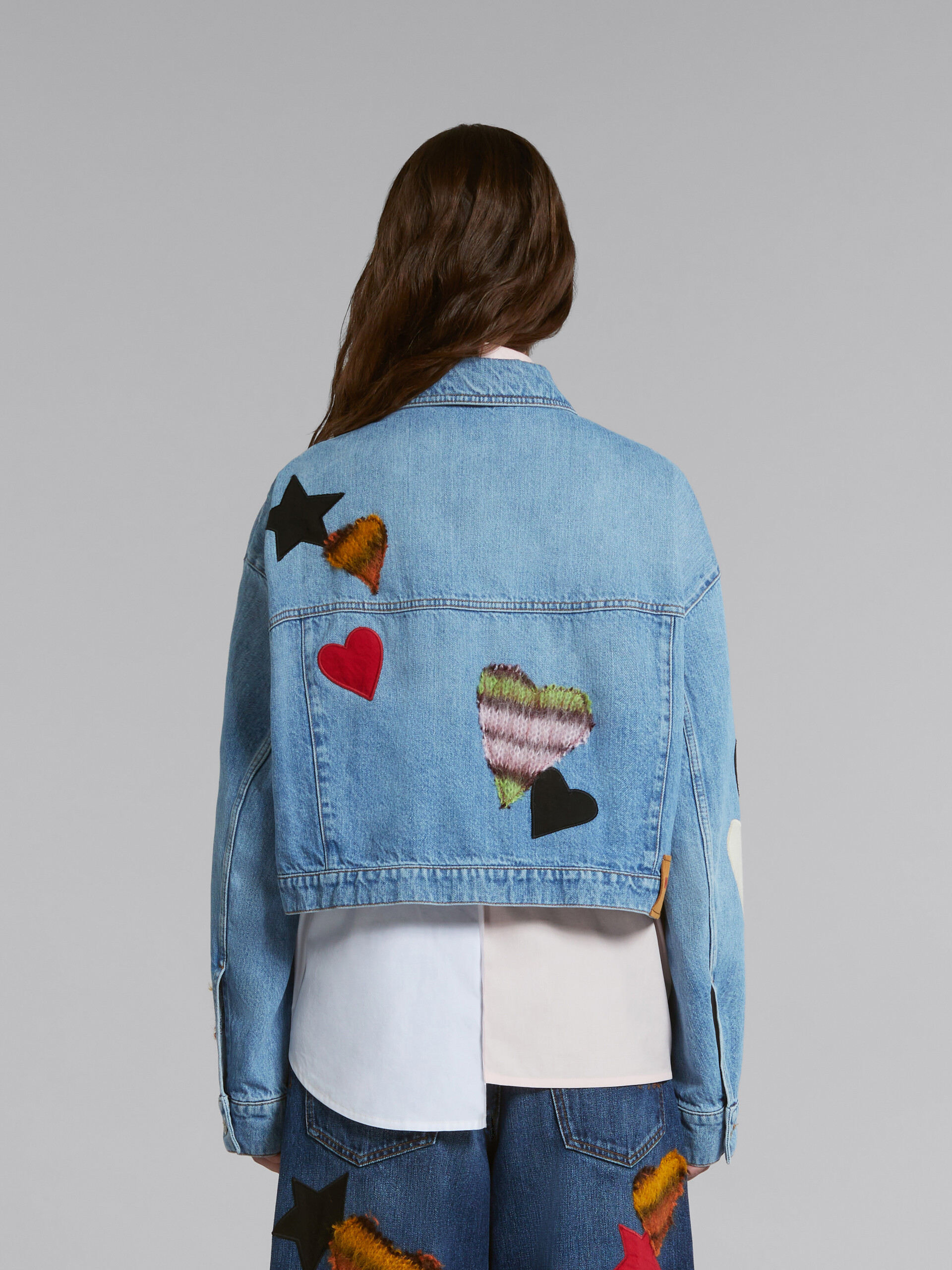 Blue denim jacket with patches